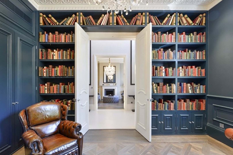 Library shelves filled with old leather bound books